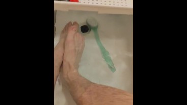 skinny twig strokes his cock and pissed in sink and shows off feet in bathtub